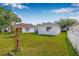 Large backyard showcasing ample green space and the home's exterior, ideal for gardening or entertaining at 18106 Canal Pointe St, Tampa, FL 33647