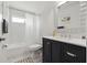 Modern bathroom with subway tile, dark vanity and marble-look floor at 18106 Canal Pointe St, Tampa, FL 33647