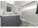 Modern bathroom with tiled shower, gray vanity, and contemporary fixtures at 18106 Canal Pointe St, Tampa, FL 33647
