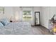 Serene bedroom with soft white walls, laminate wood flooring, and bright natural light at 18106 Canal Pointe St, Tampa, FL 33647