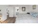 Bedroom showcasing wood-look flooring, a walk-in closet and ensuite bath at 18106 Canal Pointe St, Tampa, FL 33647