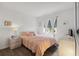 Charming bedroom with wood floors and pink bedding, complemented by bright, natural light at 18106 Canal Pointe St, Tampa, FL 33647