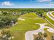 Aerial view of a pristine golf course with lush fairways and scenic sand traps at 18106 Canal Pointe St, Tampa, FL 33647