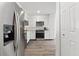 Sleek kitchen with stainless steel refrigerator, modern appliances, and bright white cabinets at 18106 Canal Pointe St, Tampa, FL 33647