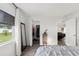 Bright bedroom with wood-look flooring, walk-in closet, and neutral color scheme at 18106 Canal Pointe St, Tampa, FL 33647