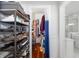 Efficient walk-in closet featuring shelves and hanging rods to maximize storage space at 1871 Prospect St, Sarasota, FL 34239