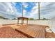 Backyard deck and pergola with fire pit and rock garden landscaping at 1912 Hawks View Dr, Ruskin, FL 33570