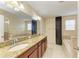 Large primary bathroom with double sinks, granite countertops and a separate soaking tub at 1912 Hawks View Dr, Ruskin, FL 33570