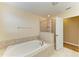 Bright bathroom featuring a large soaking tub and a glass-enclosed shower at 1912 Hawks View Dr, Ruskin, FL 33570