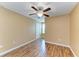 This bedroom features wood-look floors, ceiling fan, and a white door at 1912 Hawks View Dr, Ruskin, FL 33570