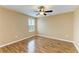 Well-lit bedroom features wood-look floors, ceiling fan, and a window with natural light at 1912 Hawks View Dr, Ruskin, FL 33570