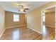 Bedroom showcasing a ceiling fan, window and wood-look floors at 1912 Hawks View Dr, Ruskin, FL 33570