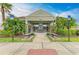 Inviting community clubhouse with stone accents, convenient benches, and lush tropical landscaping at 1912 Hawks View Dr, Ruskin, FL 33570