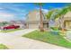 Two story home featuring a two-car garage, neutral stucco, manicured lawn and tropical landscaping with palm trees at 1912 Hawks View Dr, Ruskin, FL 33570