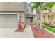 Close up of front door with stone accents, desert landscaping and a two-car garage at 1912 Hawks View Dr, Ruskin, FL 33570