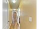 Long hallway with hardwood floors and multiple doorways at 1912 Hawks View Dr, Ruskin, FL 33570
