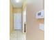 Hallway with tile flooring, alarm system control and access to other rooms at 1912 Hawks View Dr, Ruskin, FL 33570