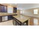 Kitchen with granite countertop island, stainless steel dishwasher and view to the spacious living room at 1912 Hawks View Dr, Ruskin, FL 33570