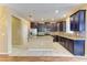 Modern kitchen features dark wood cabinets, stainless steel appliances, granite counters, and a central island at 1912 Hawks View Dr, Ruskin, FL 33570