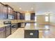 Kitchen with stainless steel appliances, granite counters, island and view of the living area at 1912 Hawks View Dr, Ruskin, FL 33570
