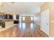 Open concept living room and kitchen area featuring dark cabinets and hardwood flooring at 1912 Hawks View Dr, Ruskin, FL 33570