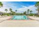 Resort-style swimming pool surrounded by palm trees and comfortable lounge chairs for relaxation at 1912 Hawks View Dr, Ruskin, FL 33570