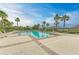 Beautiful swimming pool featuring a brick-lined perimeter, sun loungers, and swaying palm trees at 1912 Hawks View Dr, Ruskin, FL 33570