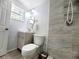 Bathroom featuring sleek vanity, updated toilet and tile shower with updated fixtures at 2035 Vinson Ave, Sarasota, FL 34232