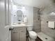 Updated bathroom featuring a modern vanity, fixtures, and a walk-in shower with stylish tile surround at 2035 Vinson Ave, Sarasota, FL 34232
