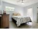Bright bedroom featuring a ceiling fan, wood-look flooring, and a large window providing ample natural light at 2035 Vinson Ave, Sarasota, FL 34232
