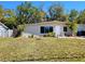 Single-story home with front yard, mature trees, and a well-maintained lawn at 2035 Vinson Ave, Sarasota, FL 34232