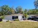 Charming single-story home featuring a well-maintained front yard and mature trees at 2035 Vinson Ave, Sarasota, FL 34232
