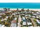 Coastal home near the beach featuring lush landscaping and neighborhood views overlooking the sparkling ocean at 204 75Th St, Holmes Beach, FL 34217