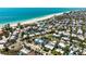 Aerial view showcasing the property's proximity to the beach and surrounding neighborhood, with tropical landscaping at 204 75Th St, Holmes Beach, FL 34217