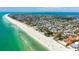 Stunning aerial shot of a beachfront community with turquoise waters, beautiful beaches, and a vibrant coastal landscape at 204 75Th St, Holmes Beach, FL 34217