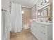Well-lit bathroom featuring elegant vanity, stylish mirror, and shower-tub combination with neutral tile at 204 75Th St, Holmes Beach, FL 34217