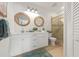 Bright bathroom boasts double vanity, modern fixtures, and glass-enclosed shower for a spa-like experience at 204 75Th St, Holmes Beach, FL 34217