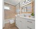 Bright bathroom featuring elegant vanity, stylish mirror, and shower-tub combination with neutral tile at 204 75Th St, Holmes Beach, FL 34217
