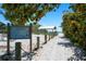 Public beach access point featuring a sign with beach rules and a shaded picnic area at 204 75Th St, Holmes Beach, FL 34217