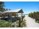 Picturesque beach with a shaded structure, soft sand, and the ocean in the background at 204 75Th St, Holmes Beach, FL 34217