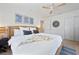 Comfortable bedroom features a woven bedframe, ceiling fan, and modern decor creating a relaxing atmosphere at 204 75Th St, Holmes Beach, FL 34217