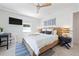 Bright bedroom featuring a woven bedframe, ceiling fan, and a modern work area for added versatility at 204 75Th St, Holmes Beach, FL 34217