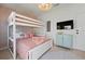 Charming bedroom with stylish decor featuring a bunk bed, decorative wallpaper, and flat screen TV at 204 75Th St, Holmes Beach, FL 34217