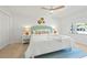 Bright bedroom with ceiling fan, shell decor, and ample natural light at 204 75Th St, Holmes Beach, FL 34217