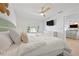 Inviting bedroom with a serene color palette, natural light, ceiling fan, and integrated entertainment center at 204 75Th St, Holmes Beach, FL 34217