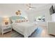 Comfortable bedroom featuring coastal decor, ceiling fan, and a window at 204 75Th St, Holmes Beach, FL 34217