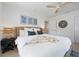 Stylish bedroom features a woven bedframe, ceiling fan, and modern decor creating a relaxing atmosphere at 204 75Th St, Holmes Beach, FL 34217