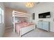 Charming bedroom with stylish decor featuring a bunk bed, decorative wallpaper, and lots of sunlight at 204 75Th St, Holmes Beach, FL 34217