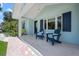 Inviting covered front porch featuring two Adirondack chairs with decorative pillows and a stylish hanging lantern at 204 75Th St, Holmes Beach, FL 34217