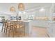 Elegant kitchen with white cabinets, quartz countertops, stainless appliances, island seating, and modern pendant lighting at 204 75Th St, Holmes Beach, FL 34217